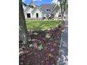 Landscaped front yard with colorful flowers and a lush green lawn surrounding a beautiful two-story home at 8146 W 875 S, Pendleton, IN 46064