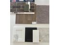 Sample of the interior design materials selected with modern paint colors, flooring, countertop, and cabinet options at 8711 Hollander Dr, Camby, IN 46113