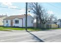 Street corner view of a single-story house with vinyl siding and updated windows at 90 N 6Th Ave, Beech Grove, IN 46107