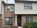 Charming townhouse featuring a brick and vinyl exterior with well-maintained landscaping at 9452 Maple Way, Indianapolis, IN 46268