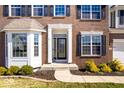 A close up showing the front door and windows of a red brick two-story house at 10155 Pepper Tree Ln, Noblesville, IN 46060