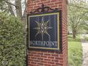 A brick pillar featuring the Northpoint neighborhood sign, surrounded by lush greenery and trees at 10343 Waveland Cir, Fishers, IN 46038