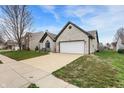 This property features a well-manicured lawn, a two-car garage, and a charming brick facade at 1086 Meadowview Ct, Franklin, IN 46131