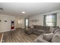 Bright living room with large windows, neutral paint, and a comfortable sectional sofa at 10946 Snowdrop Way, Indianapolis, IN 46235