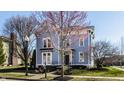 Charming blue two-story home with manicured lawn and an inviting front porch at 12895 Grenville St, Carmel, IN 46032