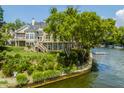 Beautiful waterfront home with a dock, lush landscaping, and a large deck for enjoying the lake views at 1326 White Water Ct, Cicero, IN 46034