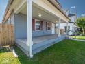 Inviting covered front porch with classic columns offers a charming space for outdoor relaxation at 1327 E Minnesota St, Indianapolis, IN 46203