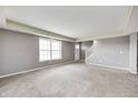 Spacious living room with neutral carpet, gray walls, white trim, and a large window for ample natural light at 1502 W 525 N, Lebanon, IN 46052