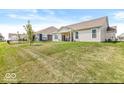 Expansive backyard featuring a large grassy area and mature trees, perfect for outdoor activities and relaxation at 17865 Haralson Row, Westfield, IN 46074