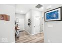 Inviting hallway with wood-look flooring, neutral paint, and stylish decor accents at 17865 Haralson Row, Westfield, IN 46074