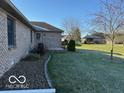Spacious backyard features a well maintained lawn, mature trees and landscaping, and a patio area at 1864 Holiday Pines Dr, Brownsburg, IN 46112