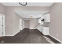Modern kitchen features white cabinets, stainless steel appliances, and dark hardwood flooring at 1924 S A St, Elwood, IN 46036