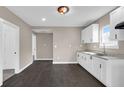 Bright kitchen with stainless steel sink, ample white cabinetry and modern fixtures at 1924 S A St, Elwood, IN 46036