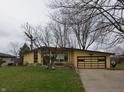 Beautiful single-story home featuring a well-manicured lawn and inviting driveway at 1936 Cunningham Rd, Indianapolis, IN 46224
