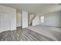 Spacious living room featuring hard surface flooring and plush carpet; a cozy and inviting space at 1952 White Oak Ln, Shelbyville, IN 46176