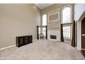 Bright living room with high ceilings, neutral carpeting, a fireplace, and large windows with elegant draperies at 2009 W 250 N, Lebanon, IN 46052