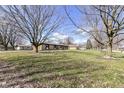 Expansive yard with mature trees offering shade and natural beauty at 202 Rainbow Blvd, Indianapolis, IN 46234