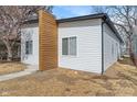 Side view featuring the home's modern architectural style, white siding, and natural wood accents at 2362 English Ave, Indianapolis, IN 46201