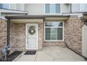 Close-up shot of the front entrance featuring a white door with a wreath and a small patio area at 256 Strand Ln # Apt C, Avon, IN 46123