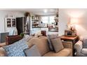 Bright living room with modern decor, stainless steel refrigerator, and open shelving at 316 Laurel St, Pendleton, IN 46064