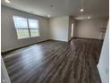 Bright living room featuring wood-look floors and abundant natural light at 3181 W Keepsake Ln, Monrovia, IN 46157