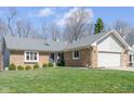 Beautiful single-story brick home with a well-maintained lawn and an attached two-car garage in a quiet neighborhood at 3334 Eden Village Pl, Carmel, IN 46033