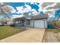 Ranch-style home featuring a covered front porch, well-manicured lawn, and driveway at 4429 Tucson Dr, Indianapolis, IN 46241