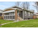Charming single-story home with a brick and gray exterior and a well-maintained front yard at 5226 E St Clair St, Indianapolis, IN 46219