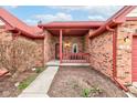 Covered front porch with red railings and brick pillars offering a cozy and inviting entrance at 528 Wind Skip Cir, Westfield, IN 46074