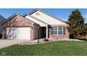 Attractive home features a manicured lawn, brick accents, and updated siding, offering great curb appeal at 5846 Edgewood Trace Blvd, Indianapolis, IN 46239