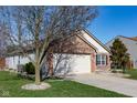 This lovely home boasts a well-maintained yard, attached garage, and charming brick and siding exterior at 5846 Edgewood Trace Blvd, Indianapolis, IN 46239