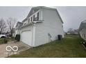Side view of a two-story home with gray siding and a well-kept lawn at 639 Rocky Meadow Dr, Greenwood, IN 46143