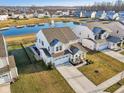 Stunning two-story home overlooking a scenic pond with fountain and lush landscaping, great curb appeal at 6630 Overlander Ln, Whitestown, IN 46075
