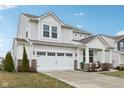 Charming two-story home featuring a two-car garage, covered porch and well-maintained landscaping at 6630 Overlander Ln, Whitestown, IN 46075