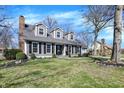 Charming gray two-story home with black shutters, dormer windows, and a well-manicured lawn at 6820 W Forest Brook Dr, Fountaintown, IN 46130