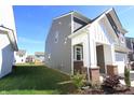 This charming home boasts a well-maintained lawn, gray siding, and classic white trim at 735 Locust Dr, Danville, IN 46122