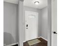 A welcoming entryway features a secure front door with glass pane and a stylish doormat at 8315 San Marcos Cir, Indianapolis, IN 46256