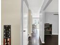 Inviting hallway with wood floors leads to a bright dining area with french doors and backyard view at 8315 San Marcos Cir, Indianapolis, IN 46256