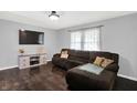 Comfortable living room boasts dark wood floors, a large sectional sofa, and a modern entertainment center at 8315 San Marcos Cir, Indianapolis, IN 46256