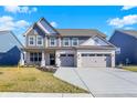 Charming two-story home with a brick facade, gray siding and a spacious two-car garage at 950 Edmonds Pl, Greenwood, IN 46143
