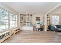 Spacious living room with hardwood floors, built-in shelving, and ample natural light at 10937 Sawgrass Dr, Fishers, IN 46037