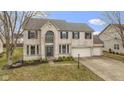 Charming two-story home with a three-car garage and brick exterior, enhanced by a well-manicured lawn at 11046 Timberview Dr, Fishers, IN 46037