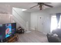 Bright living room featuring sleek flooring, a staircase and a classic ceiling fan at 1217 N Mount St, Indianapolis, IN 46222