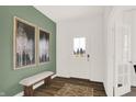 Bright entryway with a bench, artwork, and a view through the front door at 1281 Sika Ln, Greenwood, IN 46143