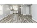Open-concept living space featuring sleek gray floors and abundant natural light, perfect for modern living at 1302 S Sherman Dr, Indianapolis, IN 46203