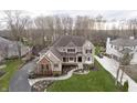 An aerial view of a tan home with well-maintained landscaping, a winding walkway, and a lush green lawn at 14577 Faucet Ln, Fishers, IN 46040