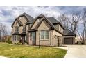 Beautiful two-story home with brick exterior, attached garage, and well-manicured lawn at 14818 Autumn View Way, Fishers, IN 46037
