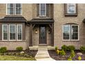 Close-up of the front door, showcasing the elegant design and welcoming entrance of the home at 14818 Autumn View Way, Fishers, IN 46037