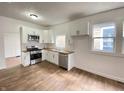 Bright kitchen with white cabinets, wood countertops, stainless steel appliances, and wood floors at 1518 Lawton Ave, Indianapolis, IN 46203