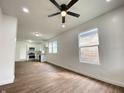 Living room with wood floors, white walls, a ceiling fan and an open view to the kitchen at 1518 Lawton Ave, Indianapolis, IN 46203